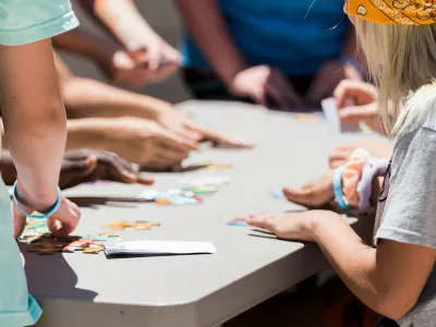Children playing a puzzle game round a table