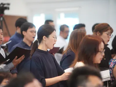 People gathered in rows at a community meeting