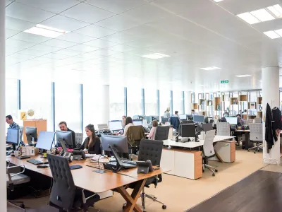 Staff at desks in an open-plan office